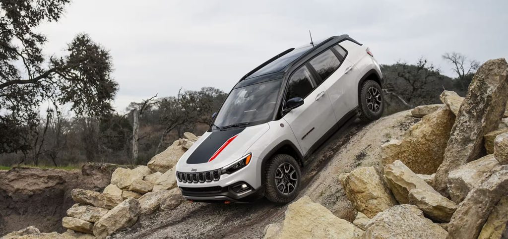 white jeep compass on rocks