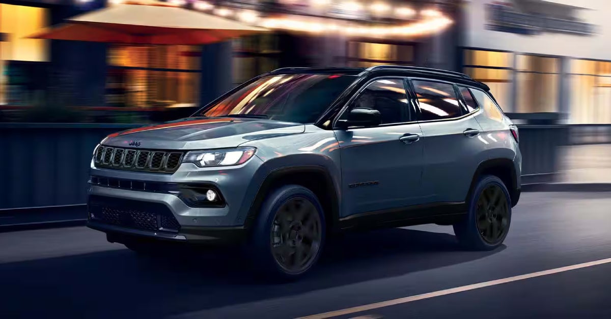 2026 Jeep Compass driving on a road with a blurry background